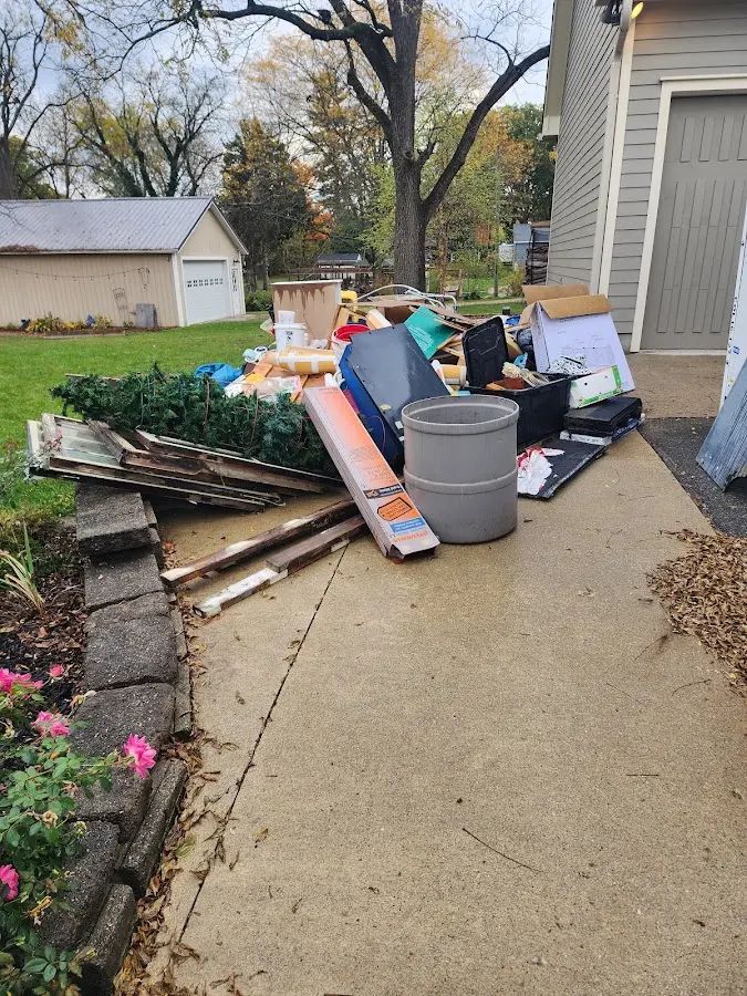 Dumpster being loaded with debris for Roofing Dumpster Rental in Spout Springs
